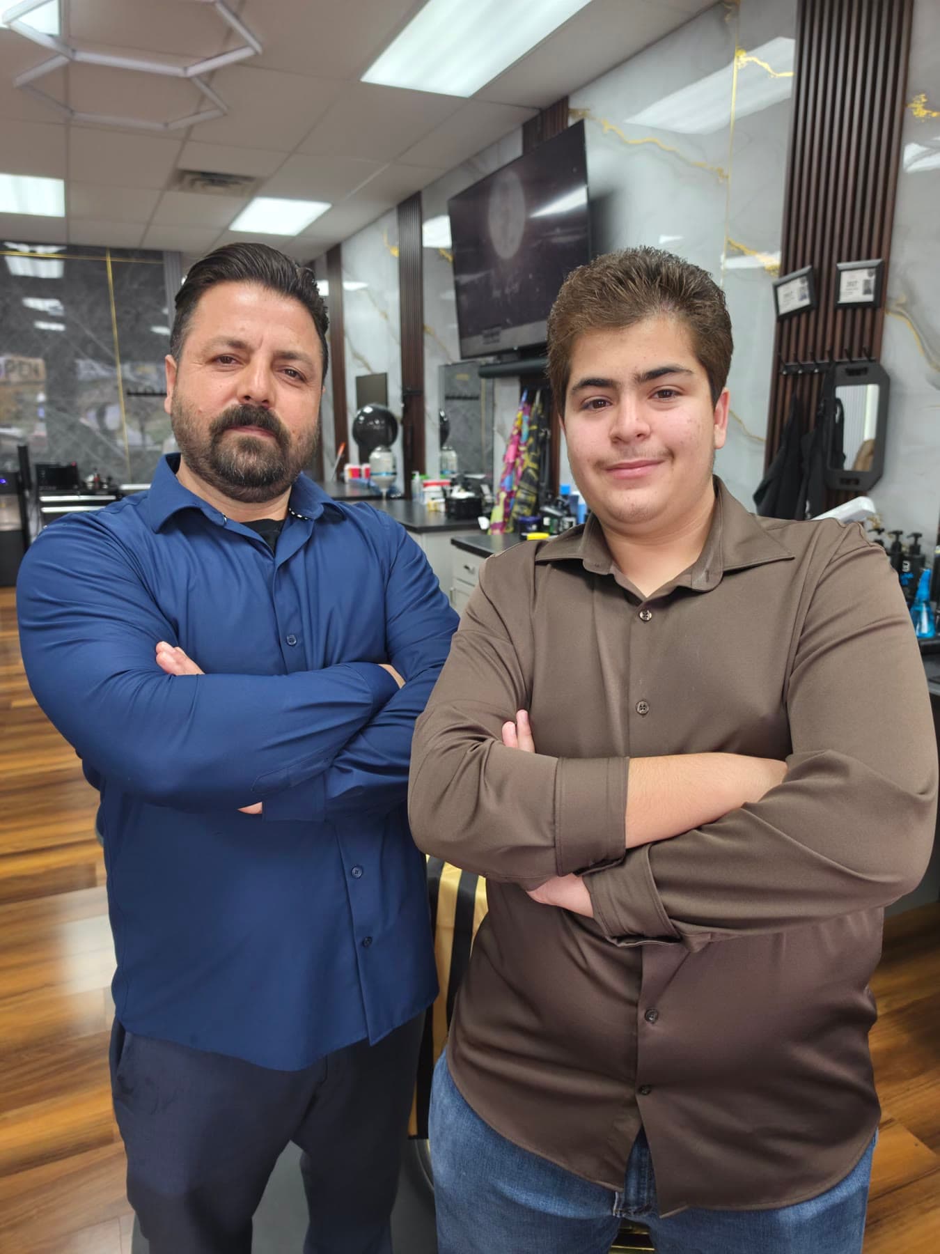 Ryad and his son Hamza, the father-and-son team behind Hamza Barbershop